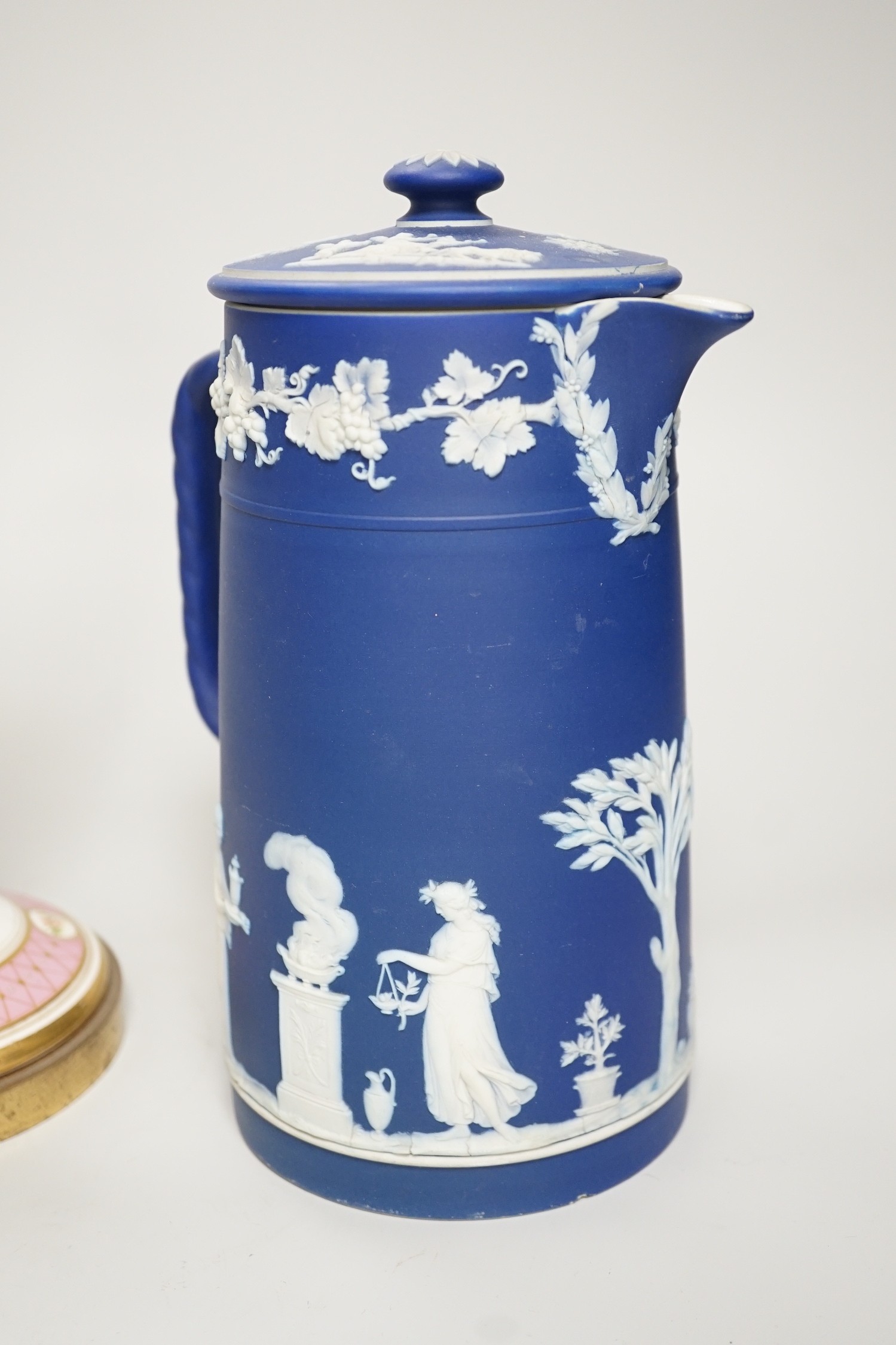 Three mid to late 19th century pieces of Wedgwood Jasperware, including a coffee pot and a small cache-pot, a pair of 19th century porcelain candlesticks converted into lamps